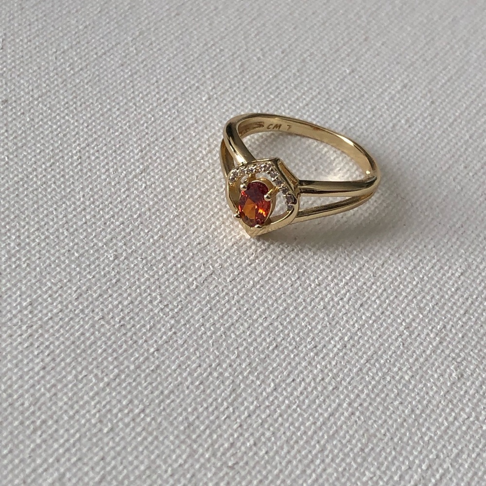 Gold Ring with Orange Center Gemstone and Halo Accent